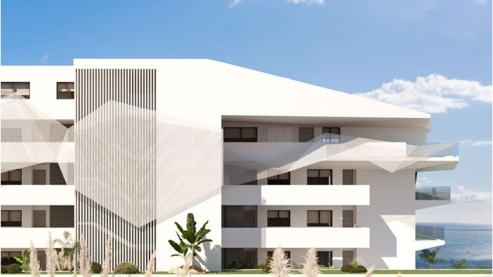 Modern wit gebouw met uitzicht op de oceaan